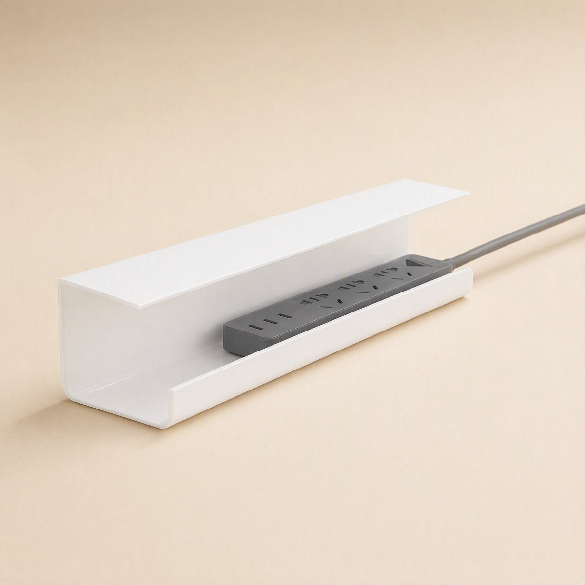 Wireledge – White covered cable box with a gray power strip resting inside and its cord trailing out