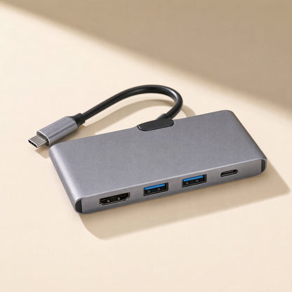 Linkspread – Compact grey hub with short cable, showing an HDMI port, two blue USB ports and a USB-C port on beige