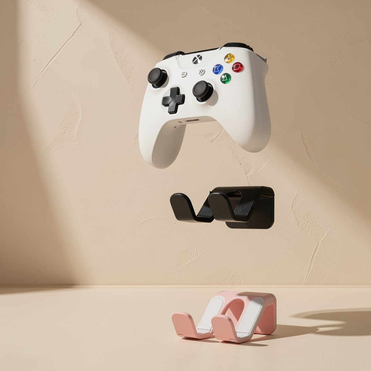 Padperch ABS Game Controller Stand in black and pink, with a white controller floating above