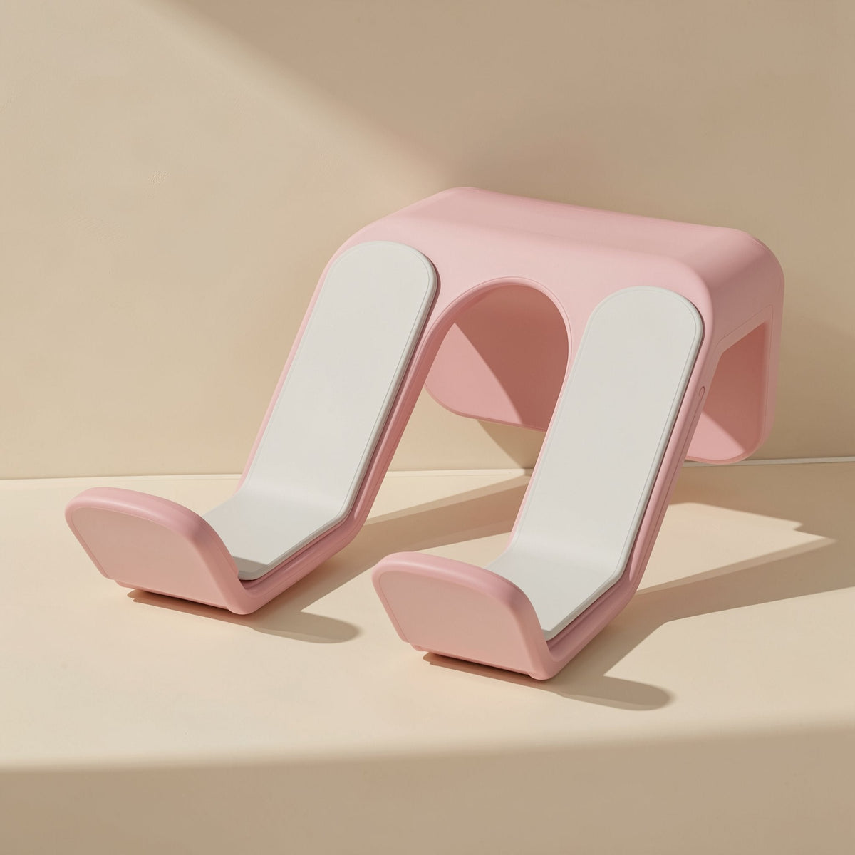 Padperch ABS Game Controller Stand – pink wall-mounted stand with white padded arms, front angle on a cream surface