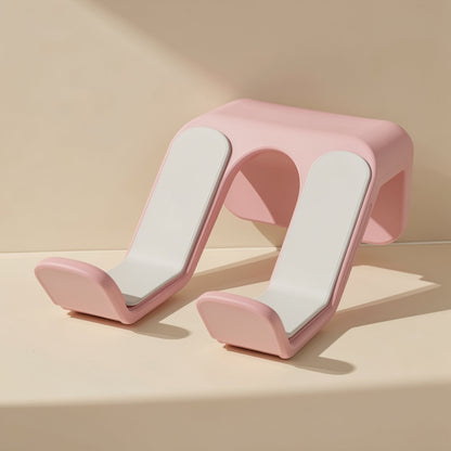 Padperch ABS Game Controller Stand – pink wall-mounted stand with white padded arms, front angle on a cream surface