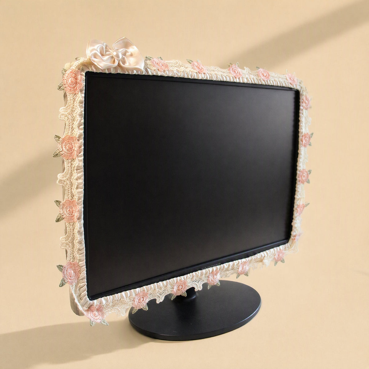 Silkdrape – Cream lace monitor cover with pink roses and green leaves, finished with a cream satin bow on a black monitor