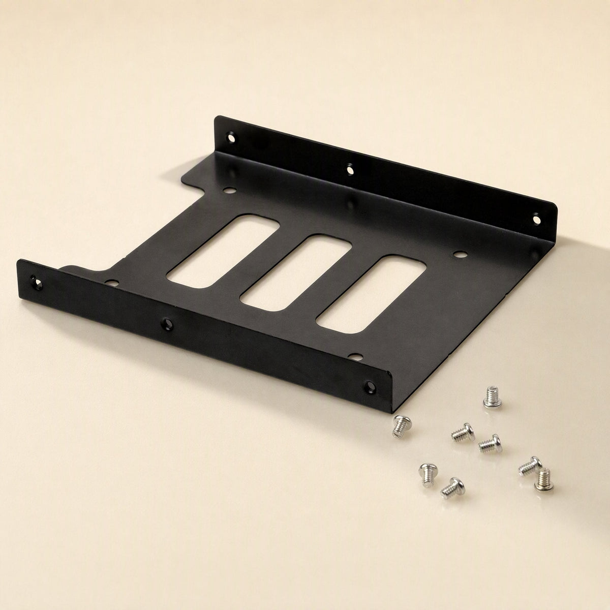 Diskfit 2.5-Inch to 3.5-Inch Hard Disk Bracket – black bracket lying flat with six silver mounting screws scattered beside it