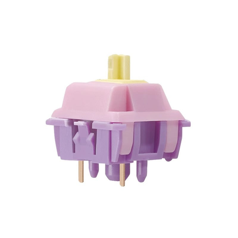 Springlet – Side view of a pink-topped switch with purple housing, yellow stem and two gold pins on a white background