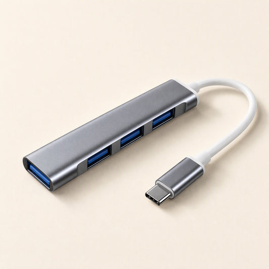 Metalbay – Space gray four-port USB hub with blue ports and white USB-C cable, angled view on a cream background
