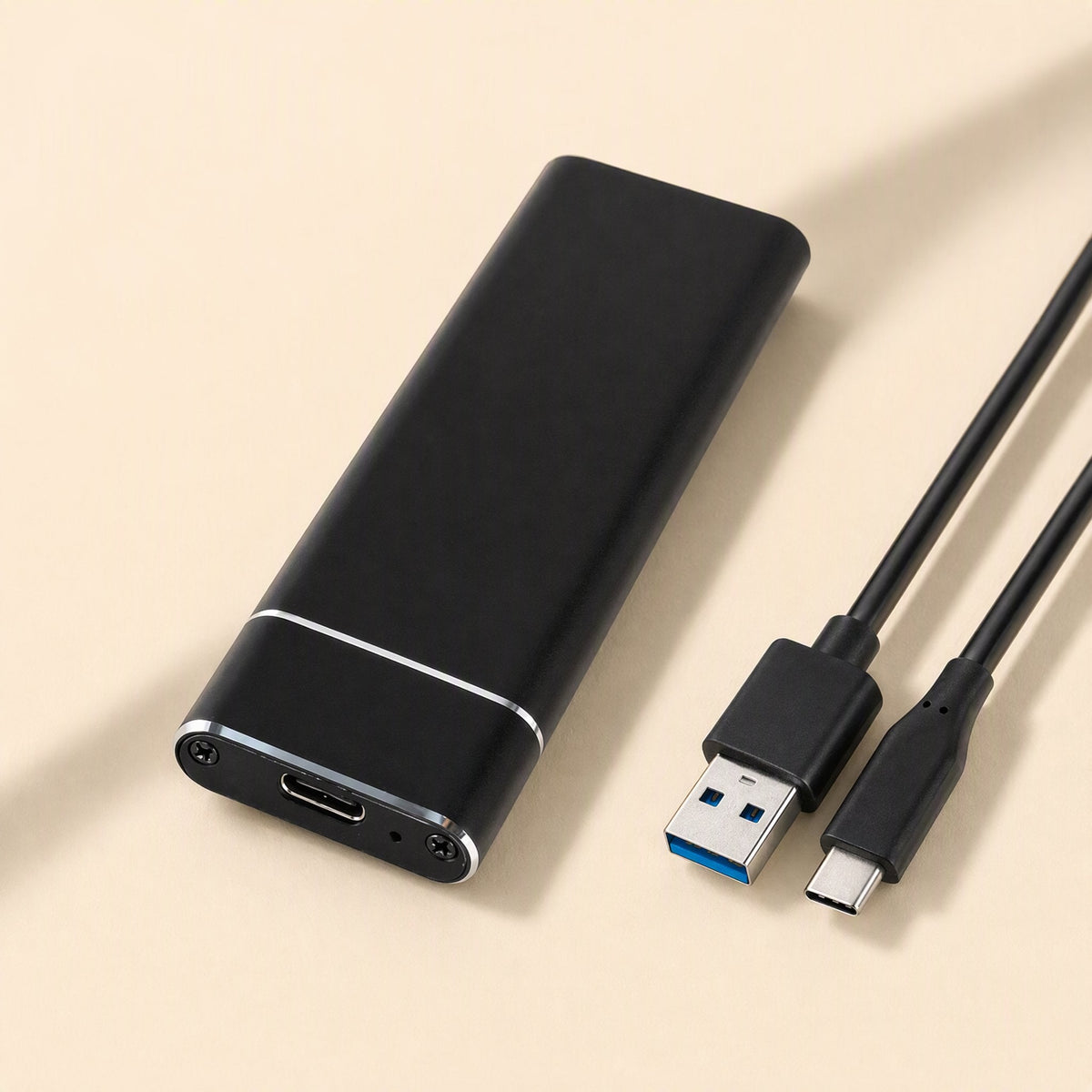 Bytecove Aluminum Alloy M.2 SSD Enclosure in black beside a USB-A to USB-C cable on a cream background
