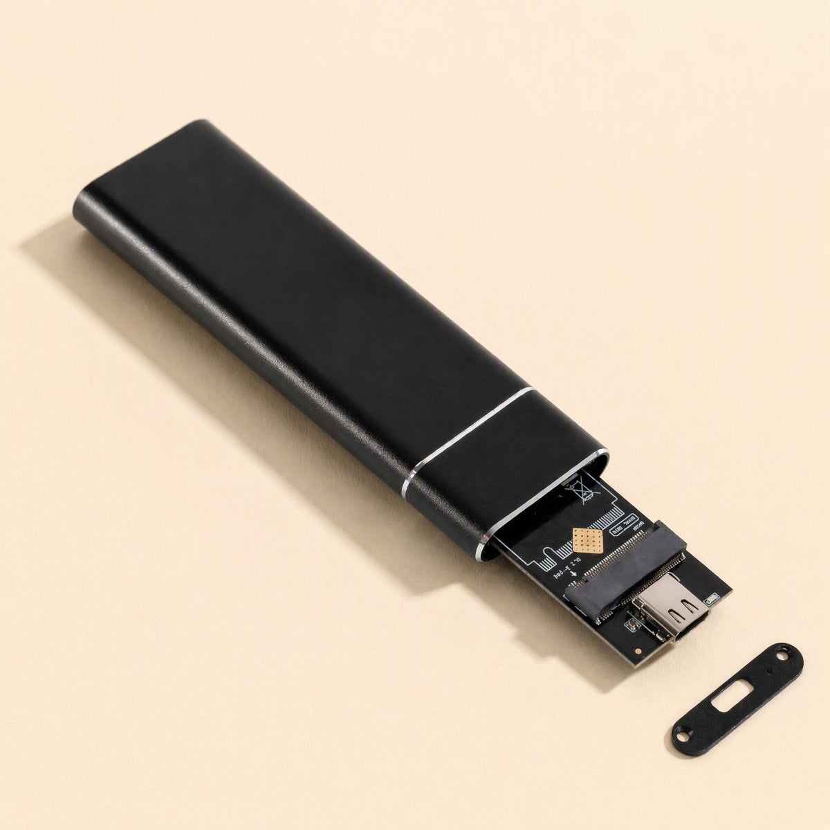 Bytecove – Black enclosure with end cap slid open, showing the internal M.2 circuit board and USB-C connector