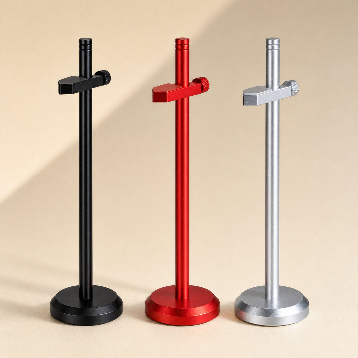 Stronghold aluminum alloy graphics card bracket in black, red and silver, shown side by side on a beige backdrop