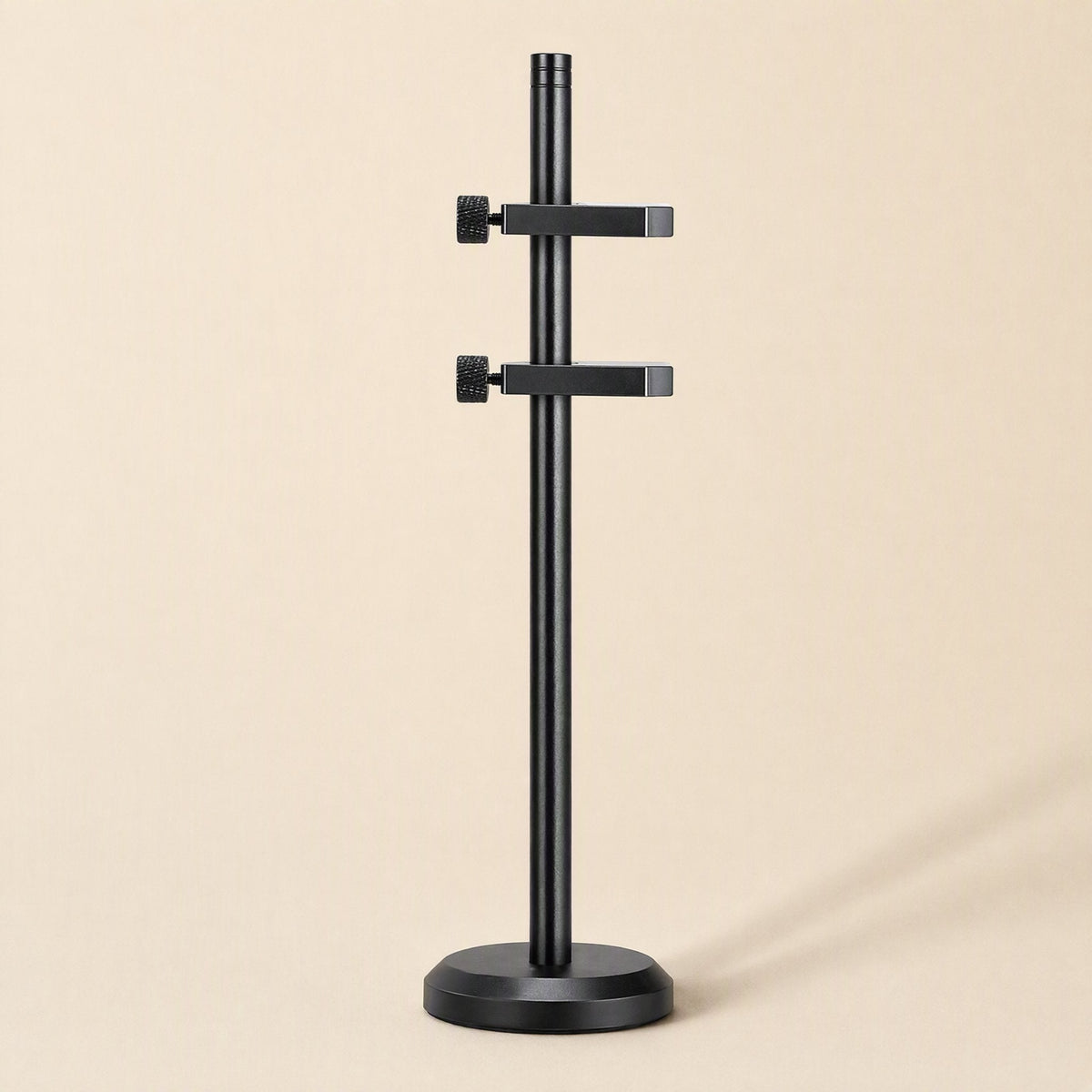 Stronghold – Black bracket with two adjustable arms and knurled thumbscrews on a round base, front view