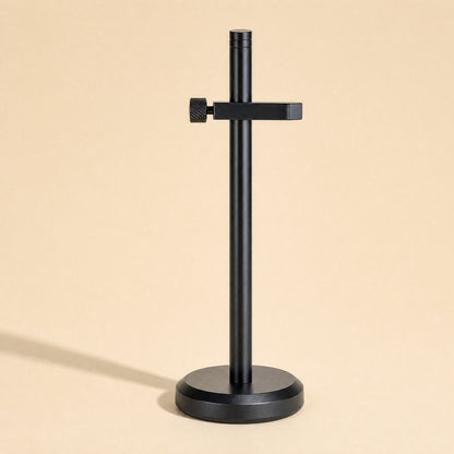 Stronghold – Black bracket with a single clamp arm and thumbscrew on a round weighted base, with a soft shadow
