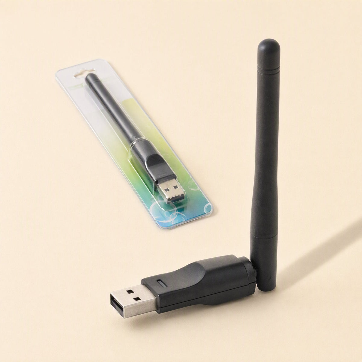 Signalstem USB Wireless Network Card with antenna upright beside its retail blister packaging on a cream backdrop