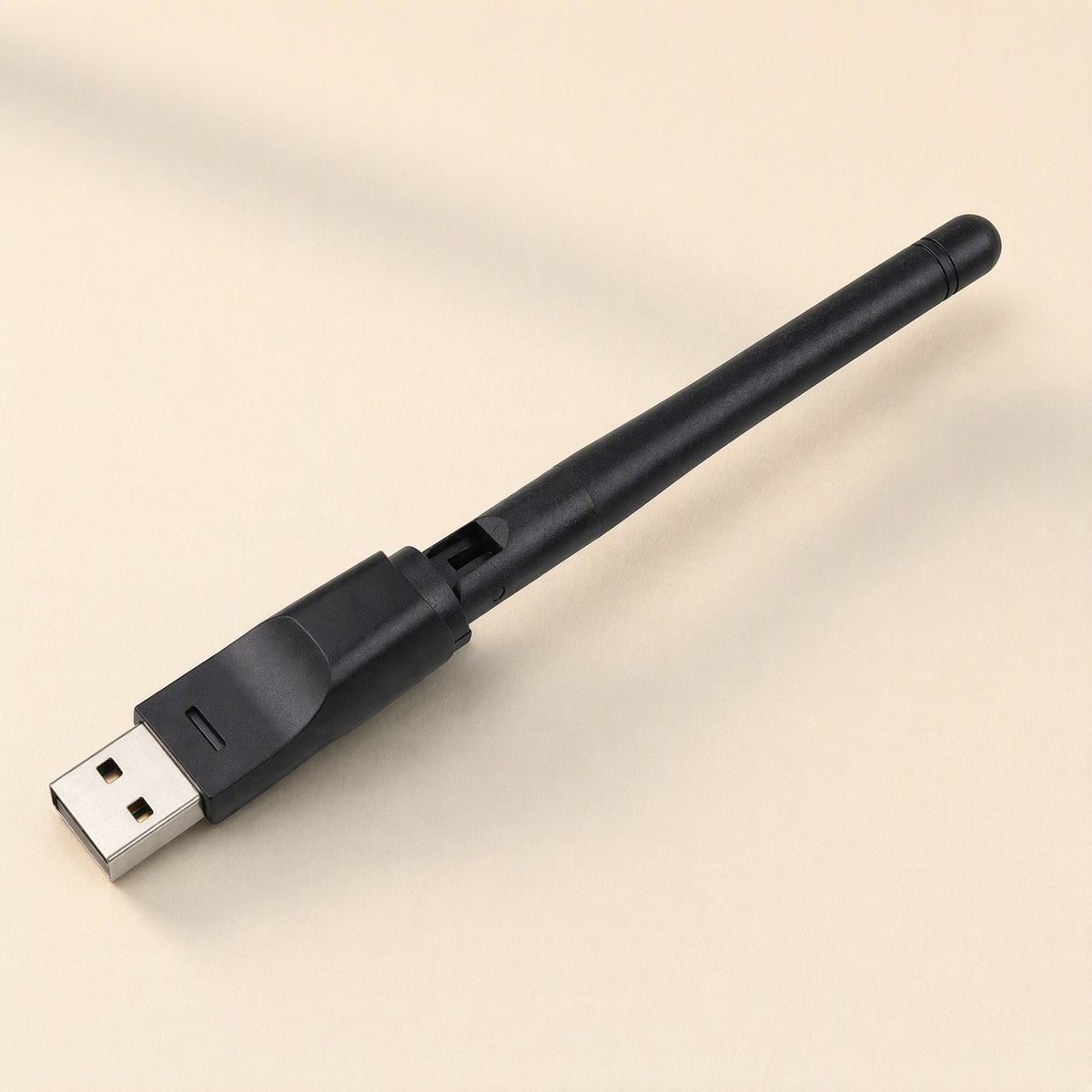 Signalstem – Top-down view of the black USB adapter with its antenna folded flat along the body