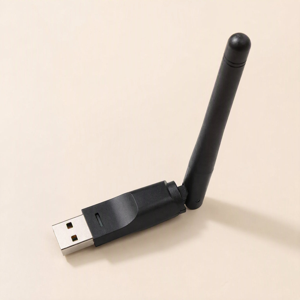 Signalstem – Black USB wireless adapter standing at an angle with the antenna raised, viewed from the connector end
