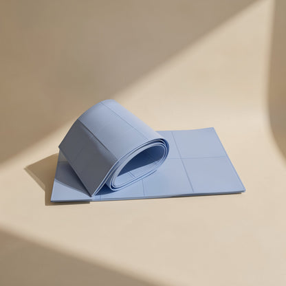 Chipchill – Blue silicone thermal pad sheet with scored squares, partly rolled up on a sunlit surface