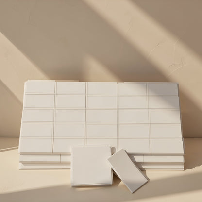 Chipchill – Stack of white scored thermal pad sheets with two cut pieces in front, against a beige wall