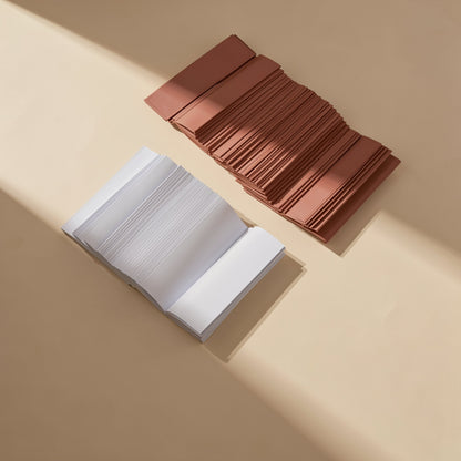 Chipchill – Pile of white thermal pad strips beside a pile of terracotta-coloured strips on a beige surface