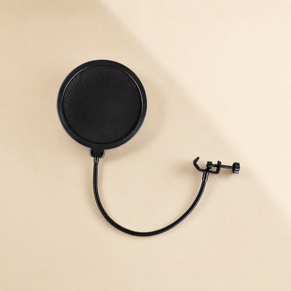 Windveil – Top-down view of the round black mesh pop filter with curved gooseneck and open clamp on a beige surface