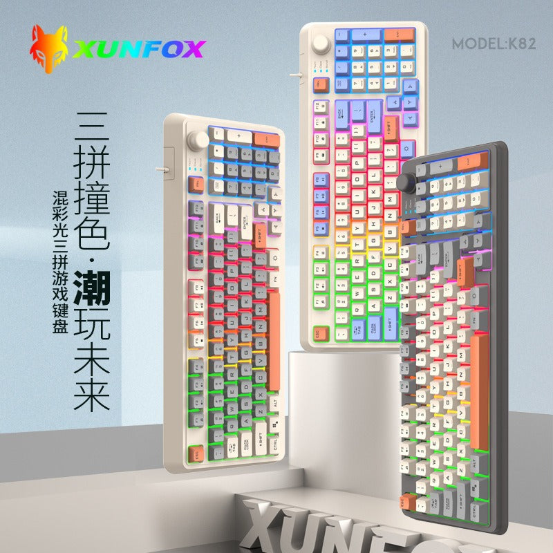 Foxglow 94-Key Wired Keyboard in cream and dark gray with orange accents, three tilted against a pastel backdrop