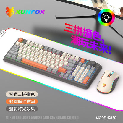 Foxglow 94-Key Wired Keyboard – gray-and-cream keyboard with orange keys and a matching mouse on a glowing RGB desk mat