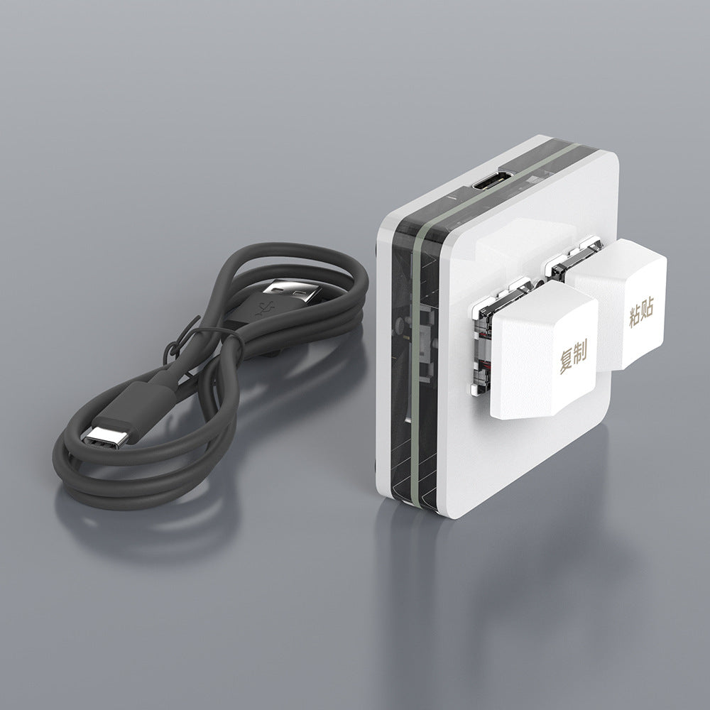 Tapnest – White two-key keypad with Chinese copy and paste keycaps beside its coiled black USB Type-C cable