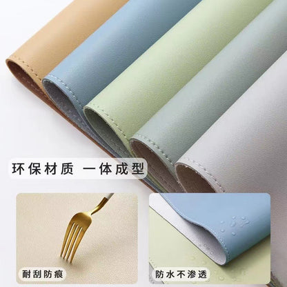 Hideloft – Five leather desk mats in tan, blue, green, grey and white, with a fork on a surface and water drops beading
