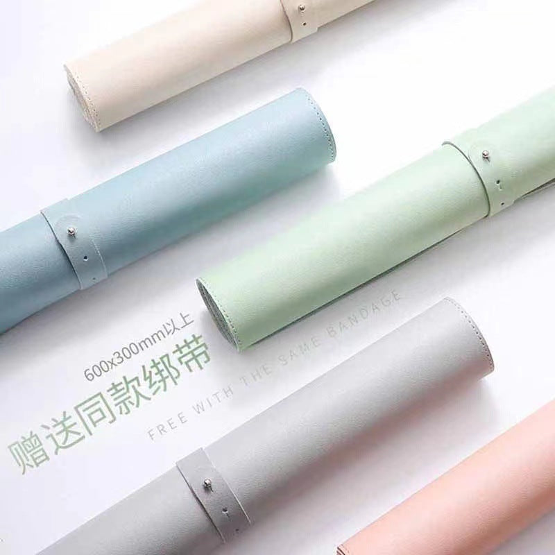 Hideloft – Five leather desk mats rolled into tubes in cream, blue, green, grey and pink, each fastened with a snap strap