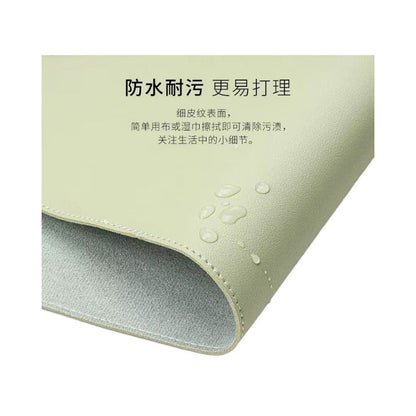 Hideloft – Green leather desk mat with a folded corner showing grey backing, with water droplets on the surface