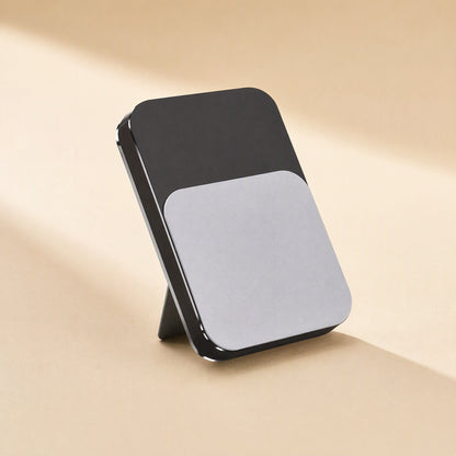 Tiltledge – Stand folded flat into a slim black and silver slab with its small support leg visible behind it