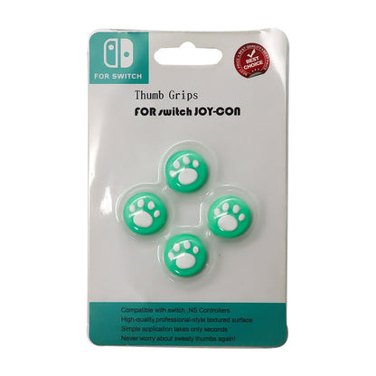Clawclick – Green and white paw print thumb grip caps, set of four on a Switch Joy-Con blister card