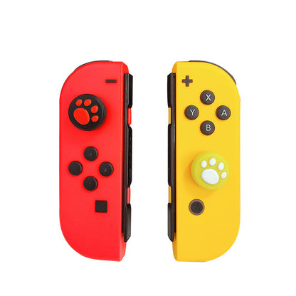 Clawclick – Joy-Con controllers in red and yellow with black-red and green-white paw print caps on the thumbsticks