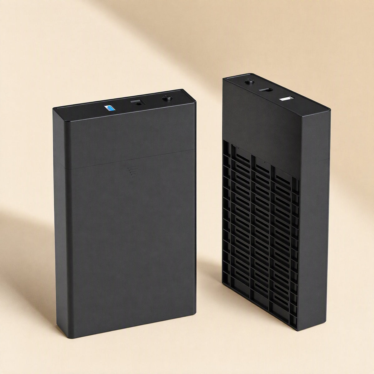 Satavault – Two black enclosures side by side, one showing the USB and power ports, the other its vented side panel