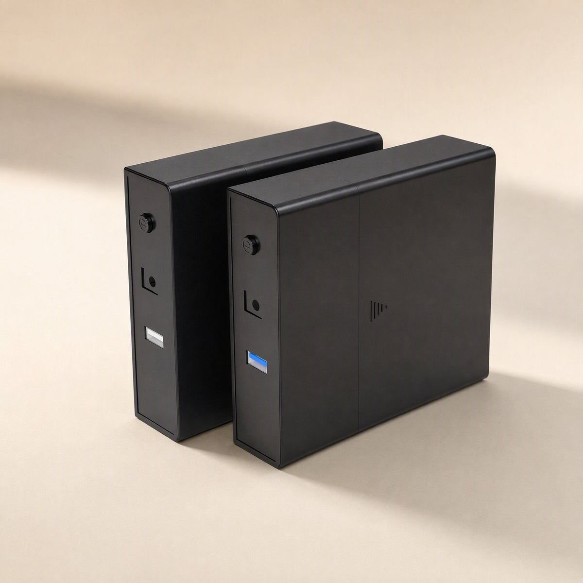 Satavault – Two black enclosures standing upright, front ports with a blue USB connector and power button visible