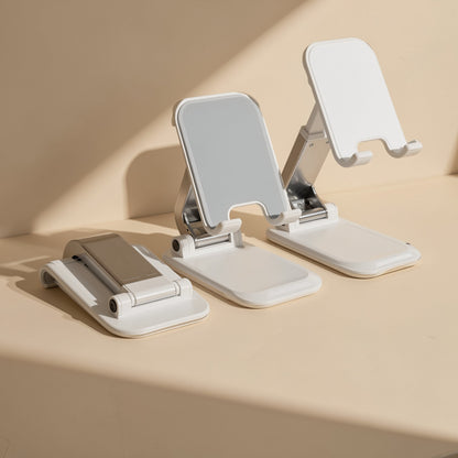 Tiltfold phone stand in white shown folded flat and open at two different tilt angles on a beige surface