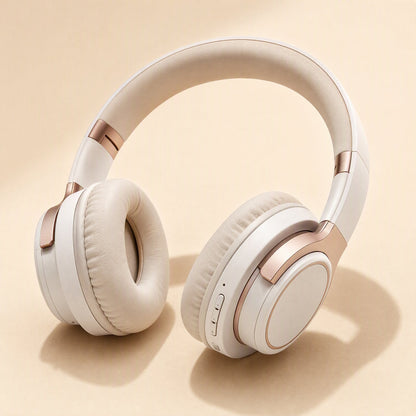 Hushsound – Cream headphones with rose gold accents, padded ear cushions and side buttons on a peach background