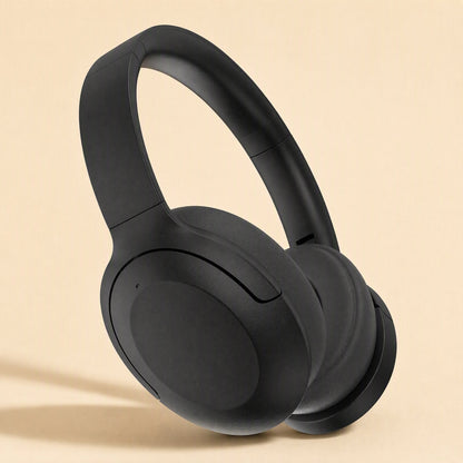 Hushsound – Black over-ear headphones tilted to show the earcup, headband and cushion against a tan backdrop
