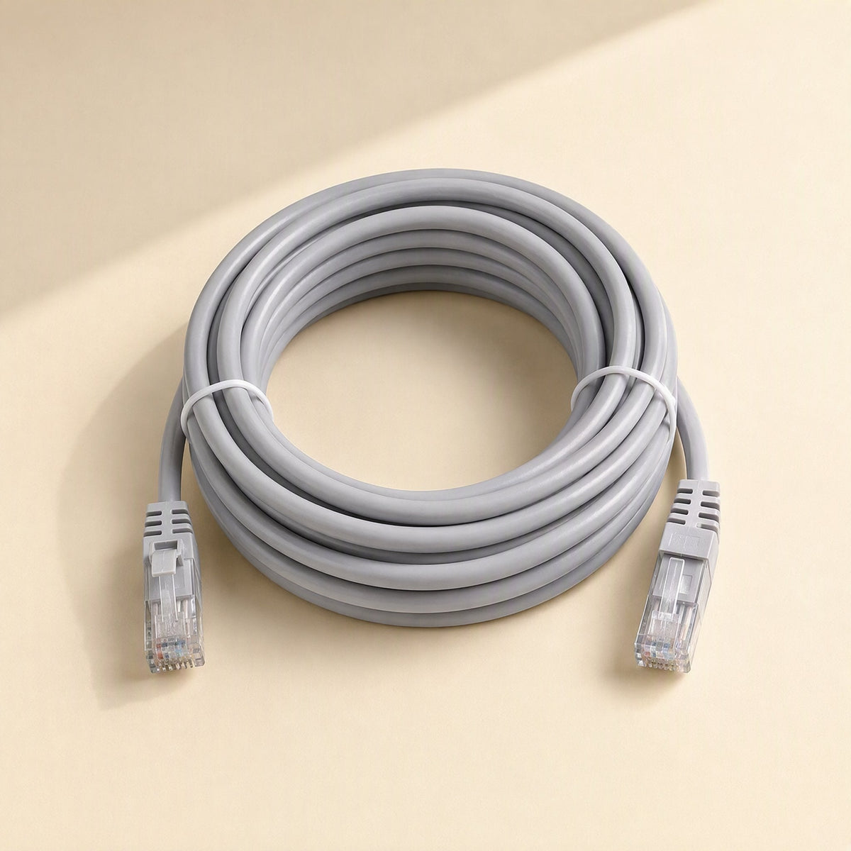 Wirebridge Cat6 Network Cable – gray coiled Cat6 cable with a white tie and RJ-45 connectors at each end on a beige surface