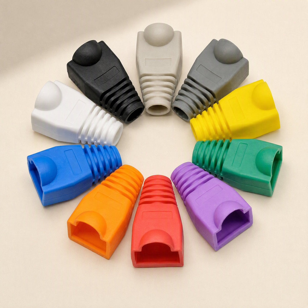 Plugcloak Category 5e RJ45 boots in ten colours arranged in a circle on a cream background