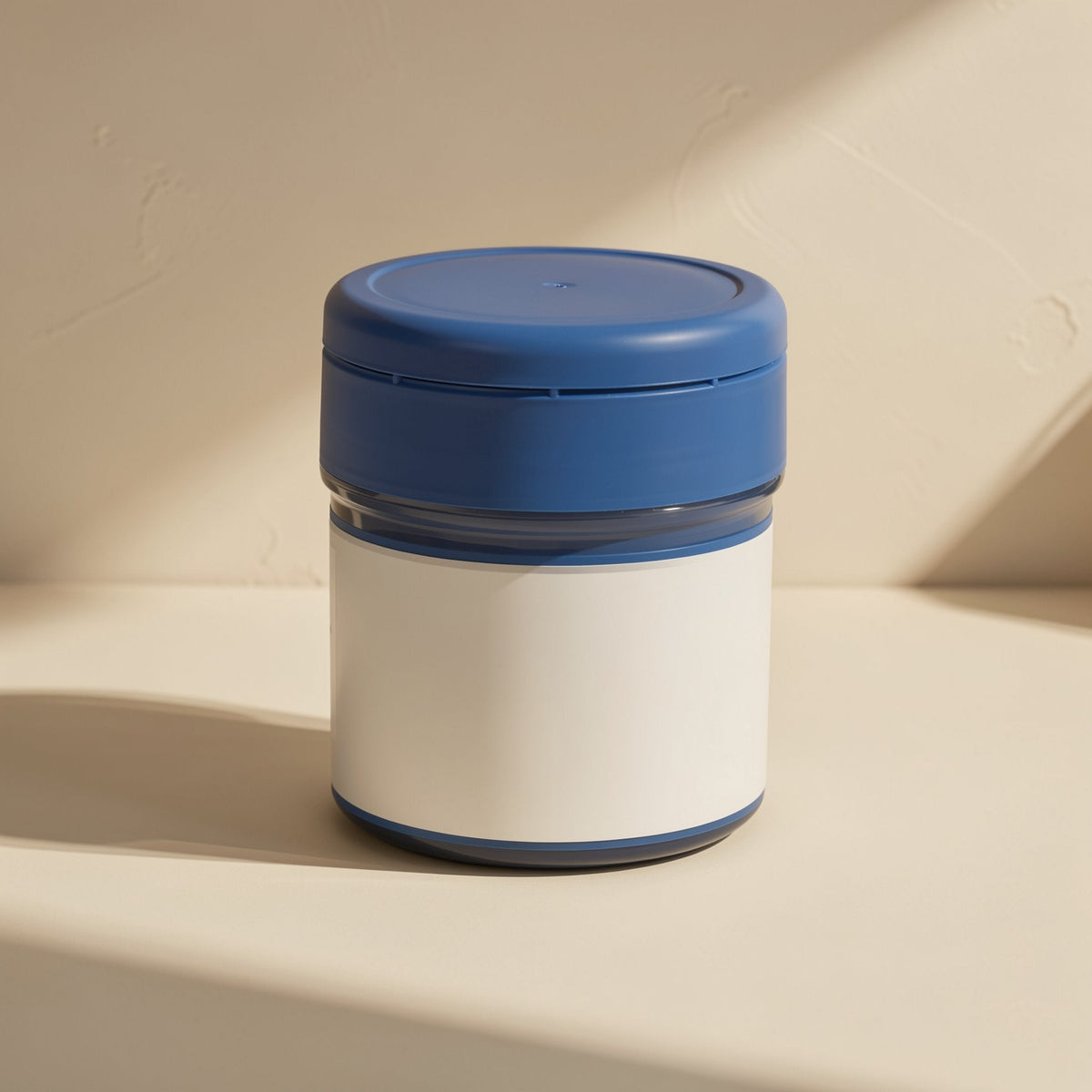 Pasteflow Bottled Silicone Thermal Paste jar with blue lid and white label on a sunlit cream surface