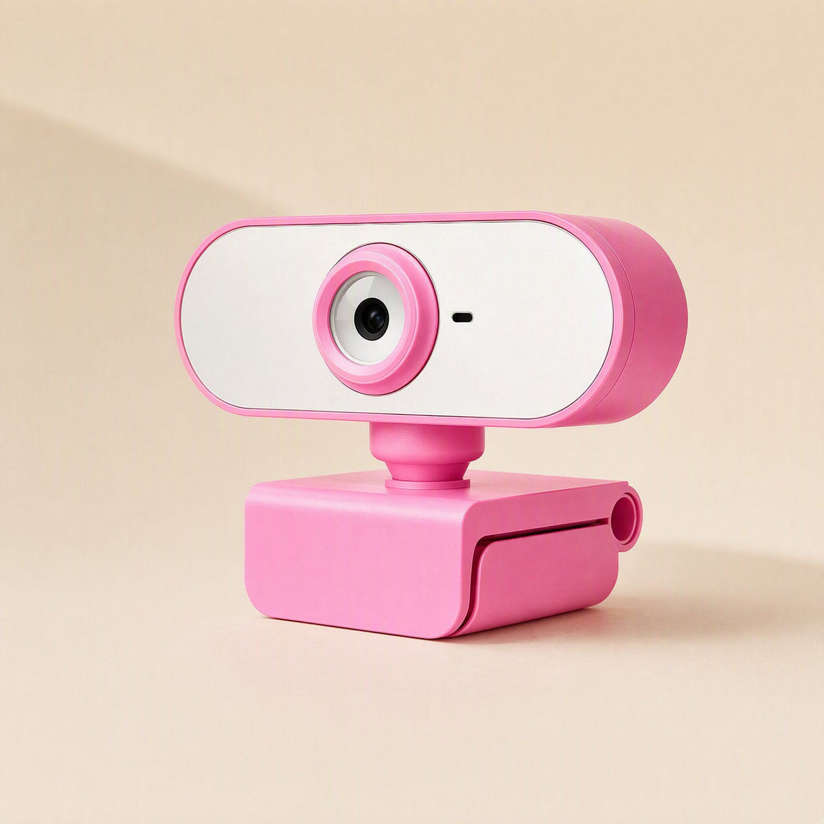 Streamface – Pink webcam with round lens and small mic dot, angled view showing the folding clip base