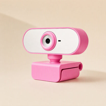Streamface – Pink webcam with round lens and small mic dot, angled view showing the folding clip base