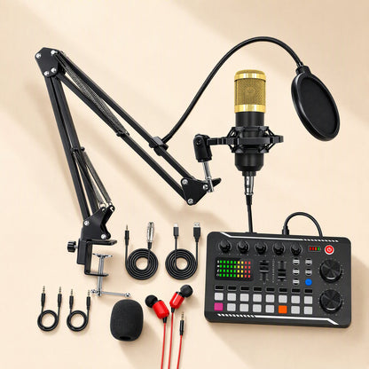 Voiceboost – Black sound card with faders and pads, gold-grille mic on boom arm, red earphones and cables laid out flat