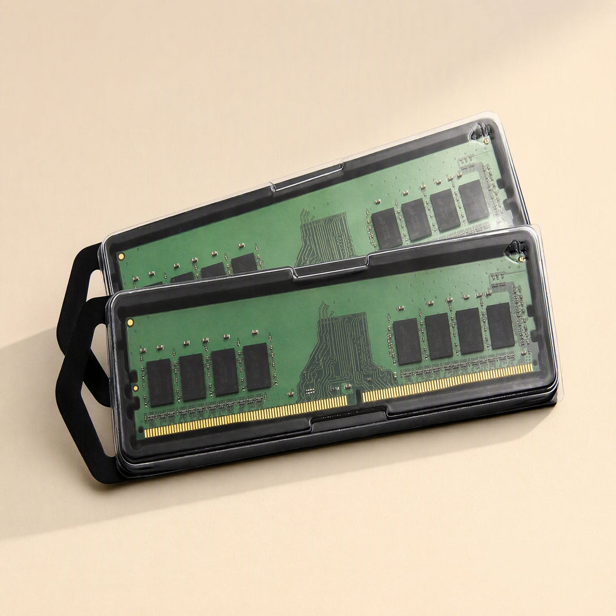 Byteboost – Two green memory modules in clear plastic cases with black tabs, stacked at an angle