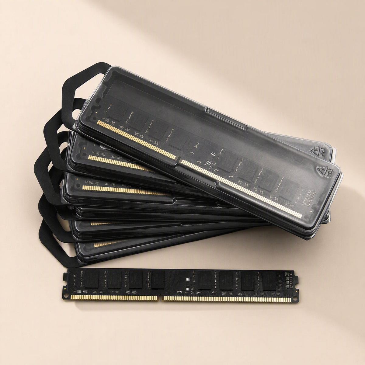 Byteboost – Stack of black memory modules in clear cases with a single black module lying in front of them