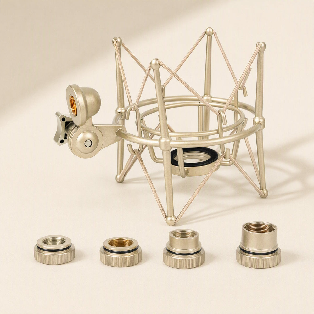 Micsteady Condenser Microphone Shock Mount in champagne gold with four threaded adapter rings in front