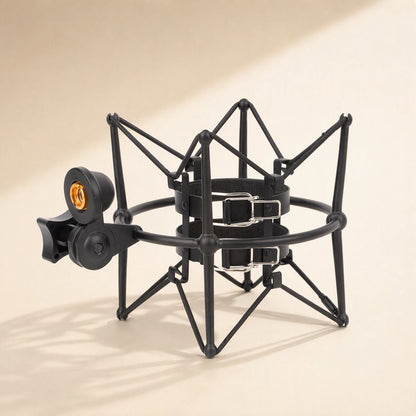 Micsteady – Black shock mount with two strap clips on the inner holder, seen from above at an angle with soft shadows
