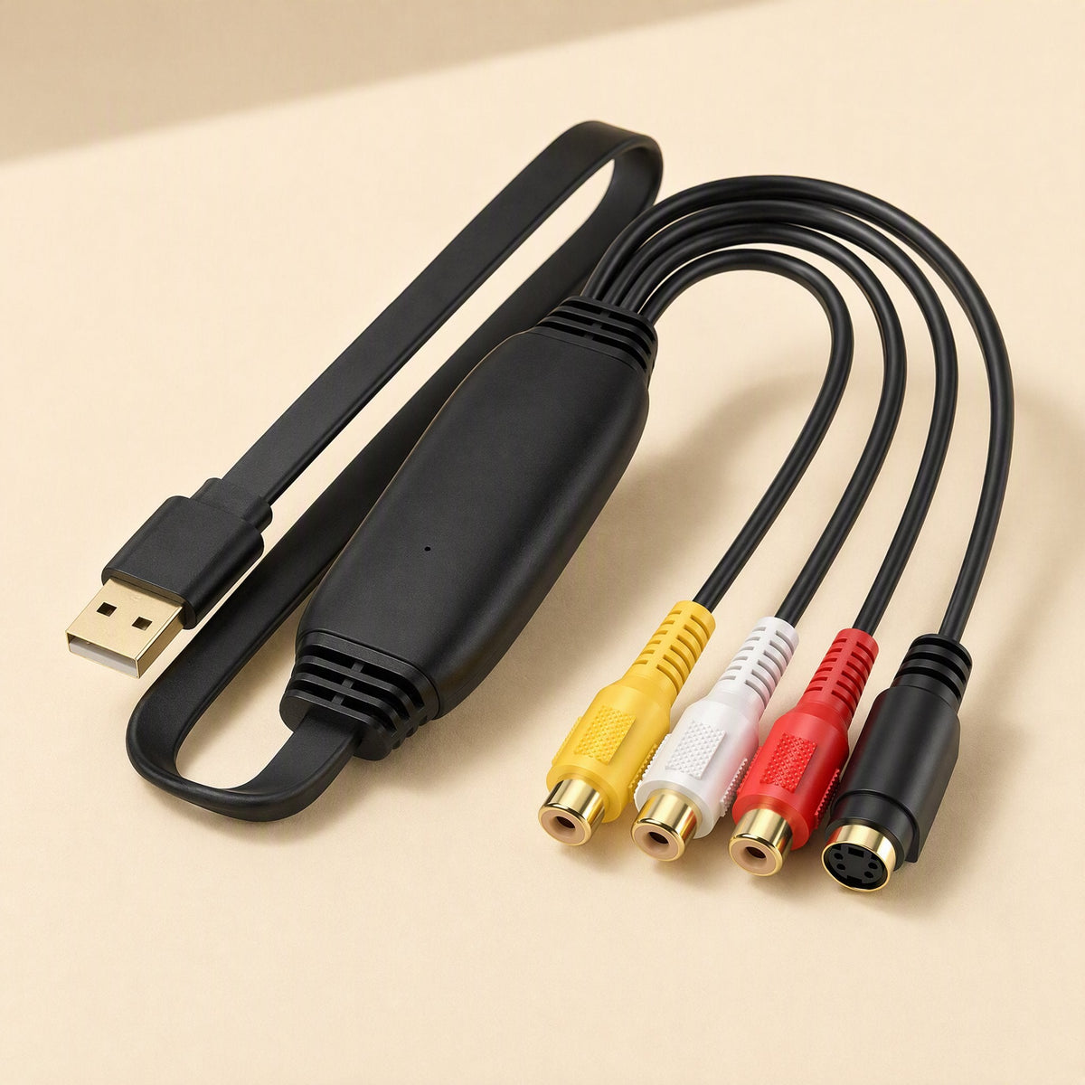 Framegrab – Black capture adapter with gold USB-A plug and four AV input jacks, angled view on a beige background