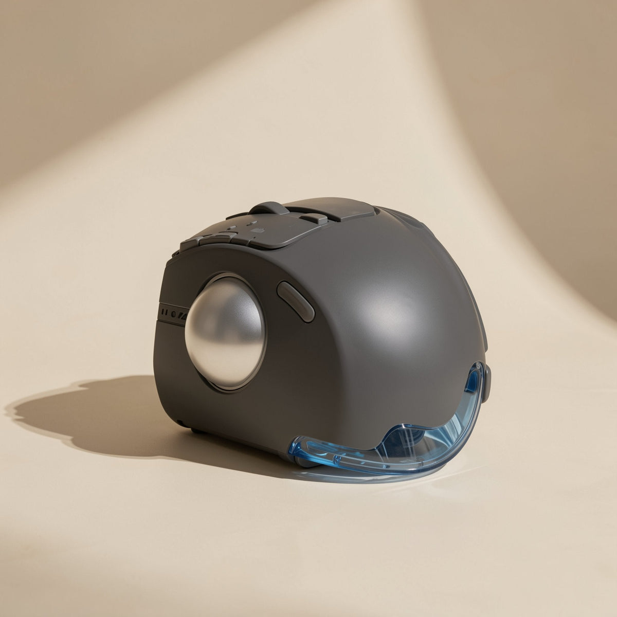 Thumbroll Wireless Bluetooth Trackball Mouse in dark gray with silver ball, side-front view on beige backdrop