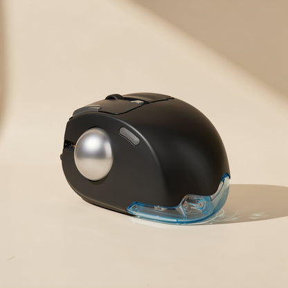 Thumbroll – Black trackball mouse from the front-left, with silver ball, thumb button and blue translucent palm rest