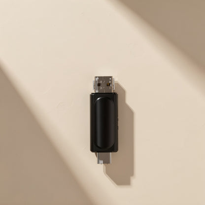 Memslot – Top-down view of the black reader showing its glossy oval panel, USB-A end up and USB-C end down