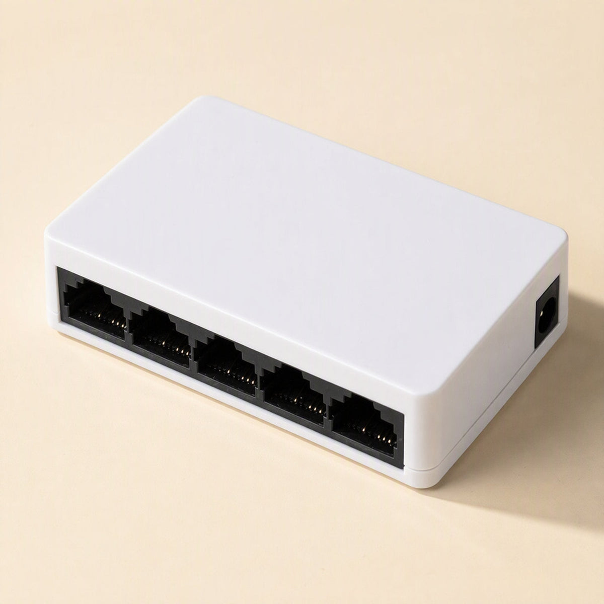 Packetweave Network Switch – compact white 5-port switch at an angle, with a DC power jack on its right side